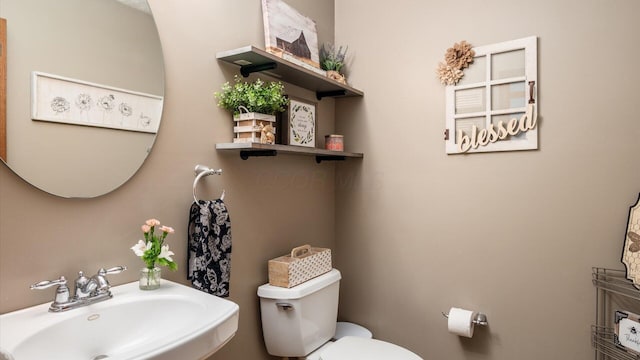 bathroom featuring toilet and sink