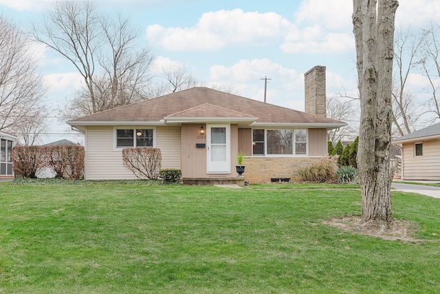 ranch-style home with a front lawn