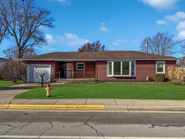 ranch-style home featuring a garage and a front yard