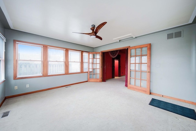 carpeted spare room with french doors and ceiling fan