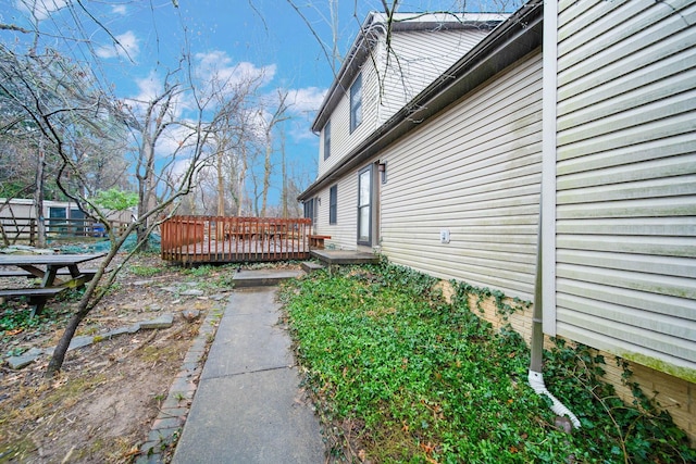 view of side of property with a wooden deck