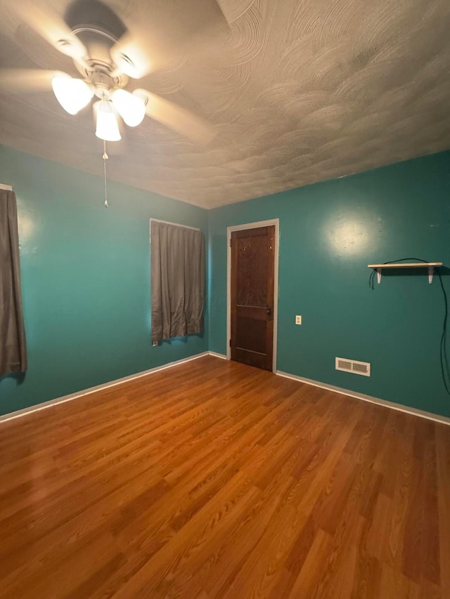 unfurnished bedroom featuring a closet, ceiling fan, and hardwood / wood-style floors