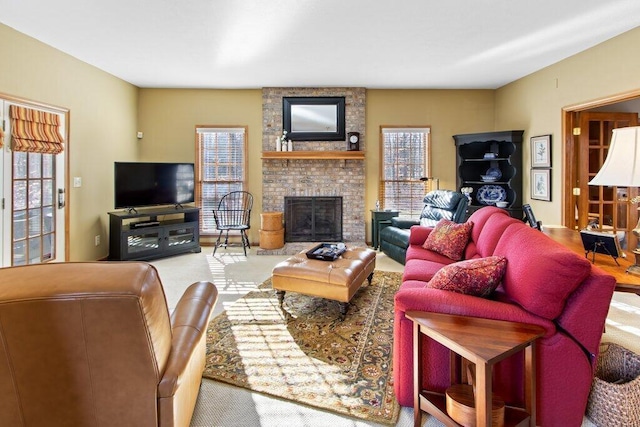 living room featuring a brick fireplace and carpet flooring