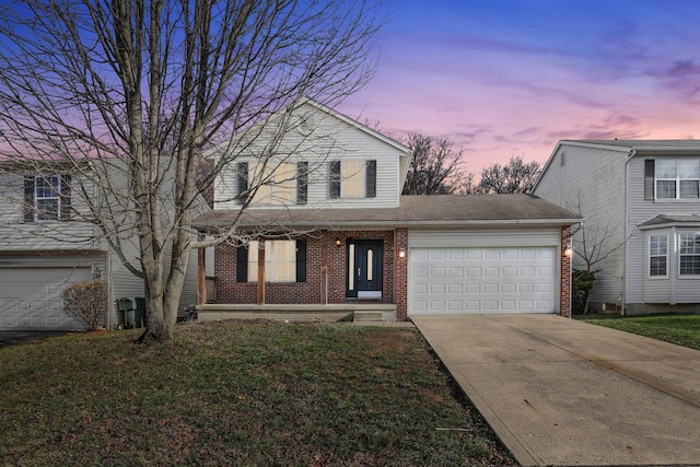 view of front property with a lawn and a garage