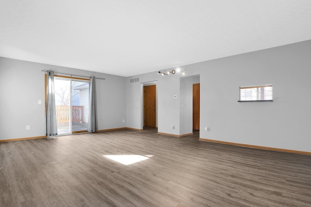 spare room with hardwood / wood-style flooring