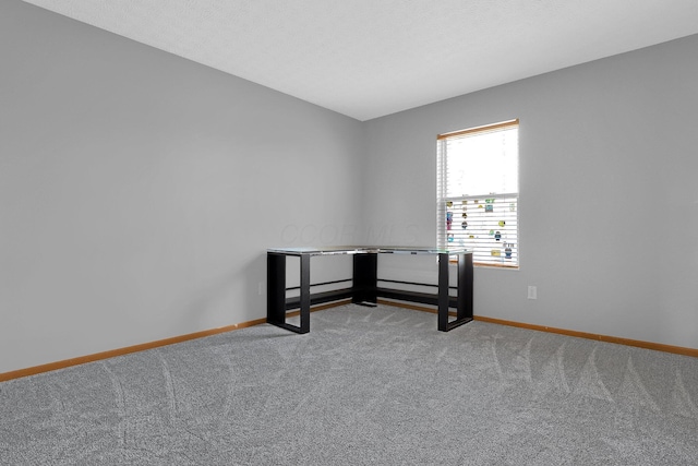 carpeted spare room featuring a textured ceiling