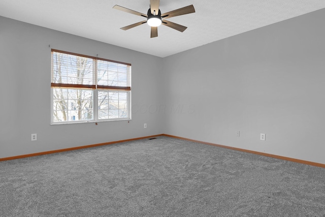 unfurnished room with carpet, ceiling fan, and a textured ceiling