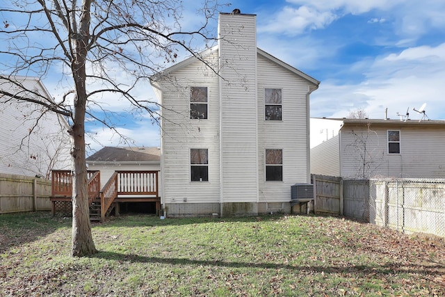 back of property with a yard, central AC unit, and a wooden deck