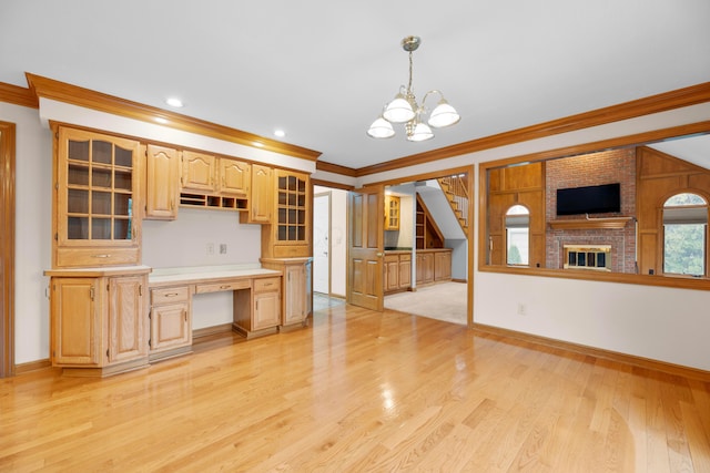 kitchen featuring light brown cabinets, light wood-type flooring, decorative light fixtures, and ornamental molding