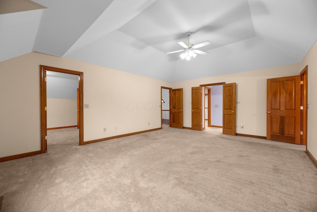 unfurnished bedroom featuring light carpet, ceiling fan, and lofted ceiling