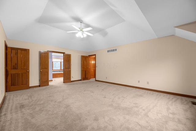 unfurnished bedroom with ceiling fan, light colored carpet, and lofted ceiling