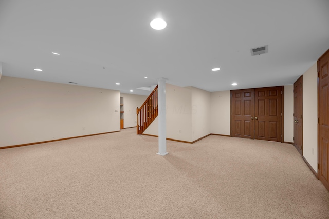 basement featuring light colored carpet