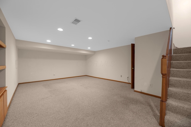 basement featuring light colored carpet