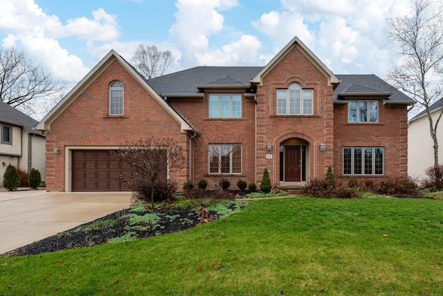 view of front property with a garage and a front lawn