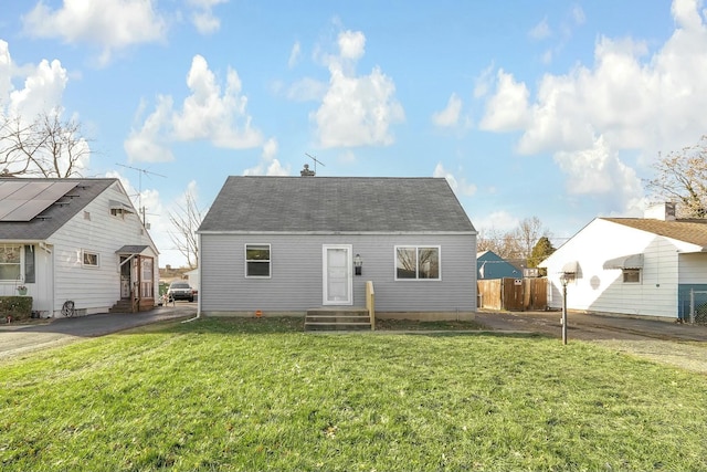 back of house with a lawn