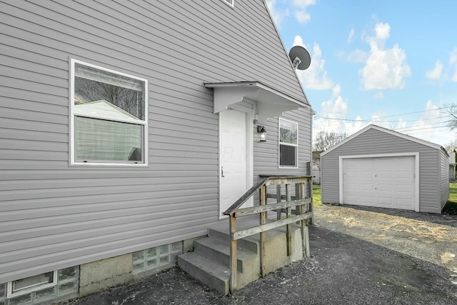 view of home's exterior with a garage and an outbuilding