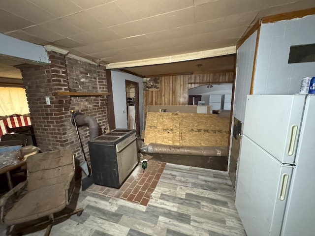 kitchen featuring wood walls and white refrigerator