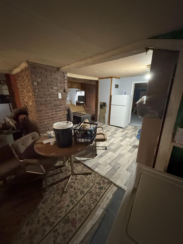 interior space featuring light hardwood / wood-style floors and brick wall