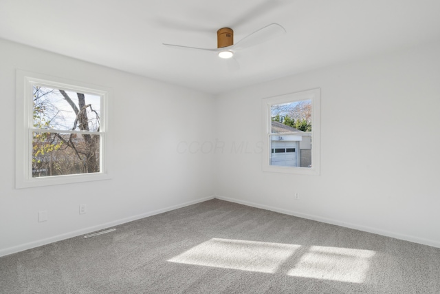 spare room featuring ceiling fan and carpet