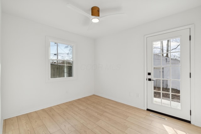 spare room featuring light hardwood / wood-style floors and ceiling fan