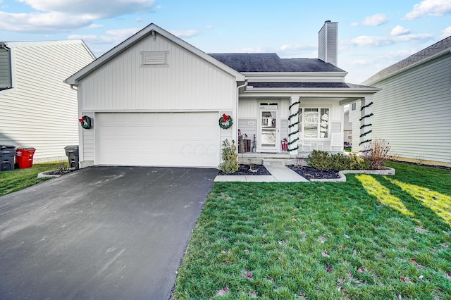 view of front of house with a front lawn and a garage