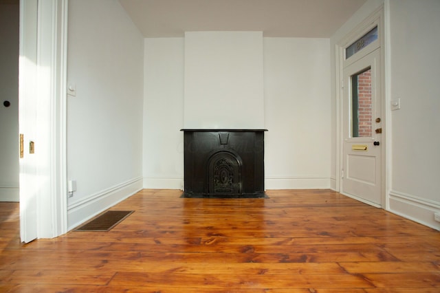 unfurnished living room with hardwood / wood-style flooring