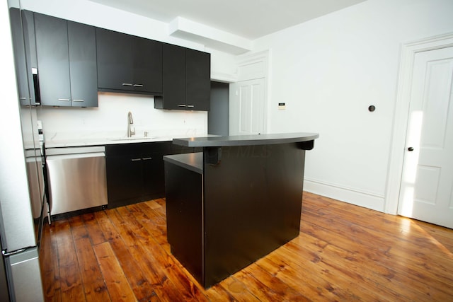 kitchen with dishwasher, a center island, sink, a kitchen breakfast bar, and dark hardwood / wood-style flooring