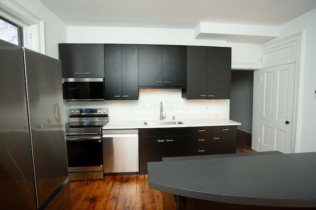 kitchen featuring dark hardwood / wood-style flooring, sink, and stainless steel appliances