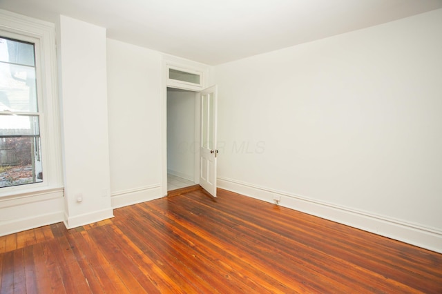 empty room featuring dark wood-type flooring