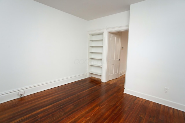 spare room featuring dark hardwood / wood-style floors