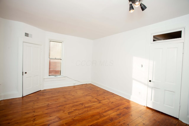 spare room with dark wood-type flooring