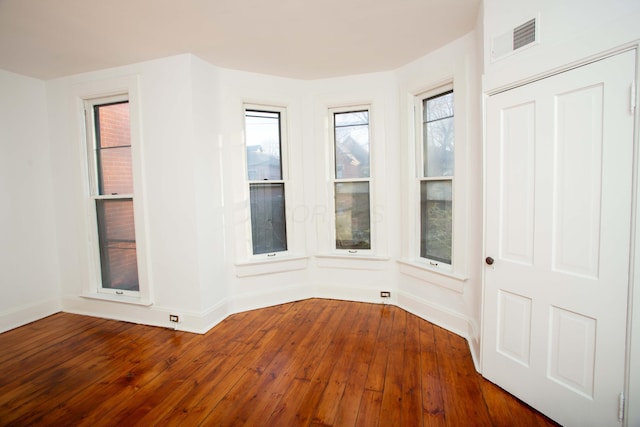 spare room with dark hardwood / wood-style floors