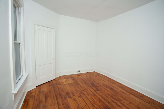 unfurnished room with wood-type flooring