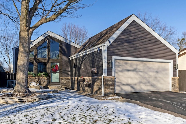 view of front facade with a garage and central AC unit