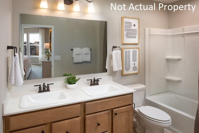 full bathroom featuring toilet, vanity, and shower / washtub combination