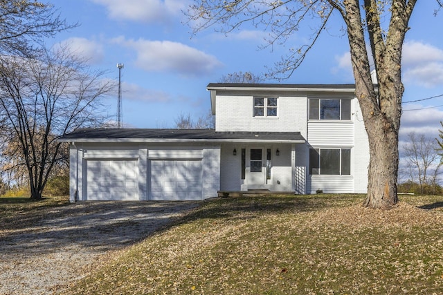 view of property with a garage, a porch, and a front yard