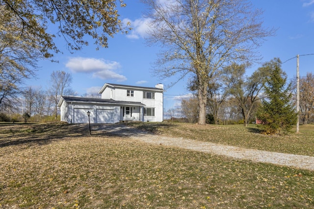 view of front of property featuring a garage and a front lawn