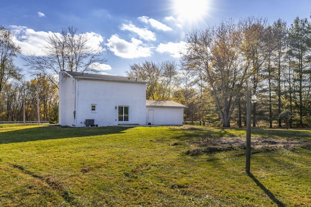 view of home's exterior with a yard and central air condition unit