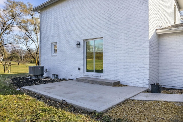 rear view of property featuring cooling unit and a patio