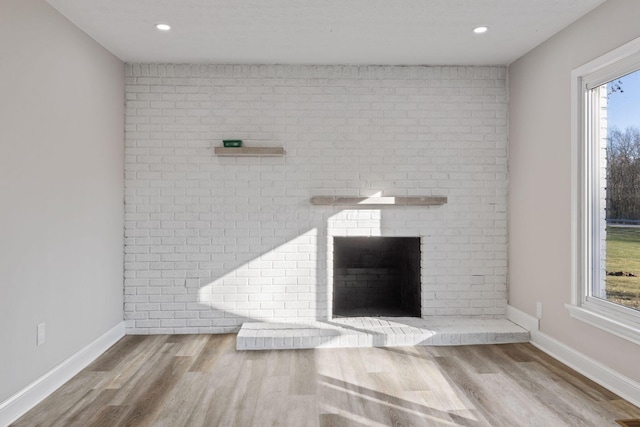 room details with wood-type flooring and a brick fireplace