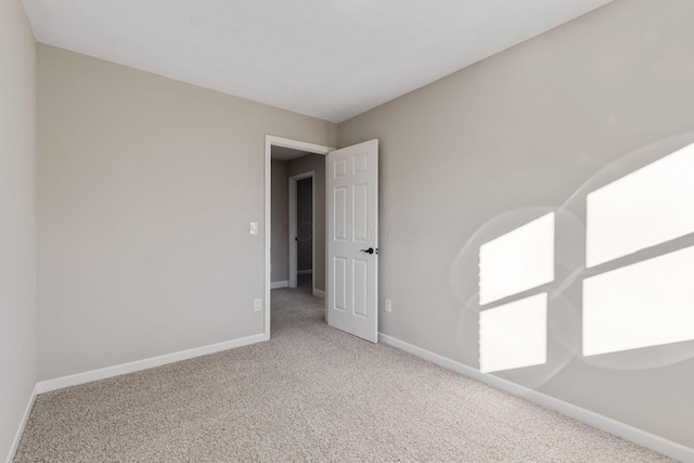 empty room featuring light carpet