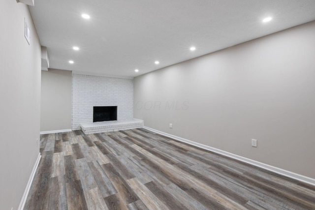 unfurnished living room with hardwood / wood-style flooring and a fireplace