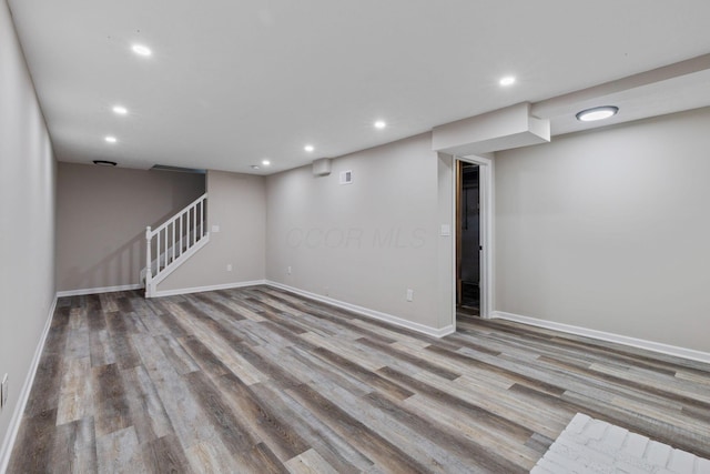 basement with light hardwood / wood-style flooring