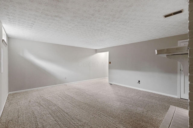 unfurnished living room featuring carpet floors and a textured ceiling