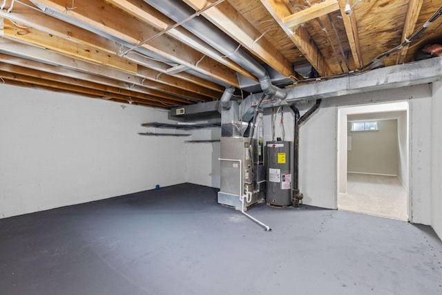 basement featuring heating unit and electric water heater