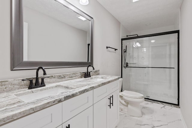 bathroom with vanity, toilet, and an enclosed shower