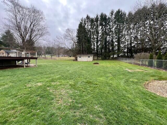 view of yard featuring a shed and a deck