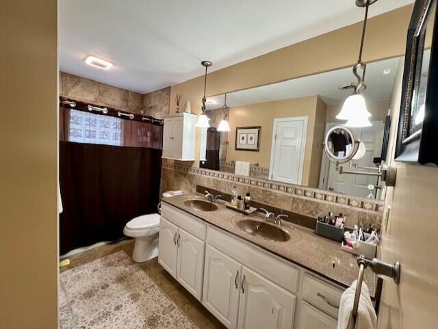 bathroom with walk in shower, decorative backsplash, vanity, and toilet