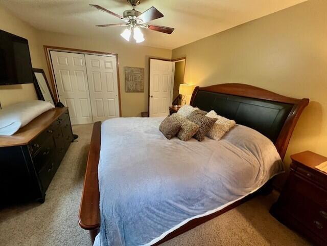 bedroom with ceiling fan and carpet floors