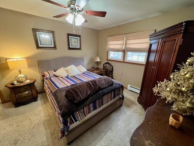 bedroom with ceiling fan, light colored carpet, and a baseboard radiator